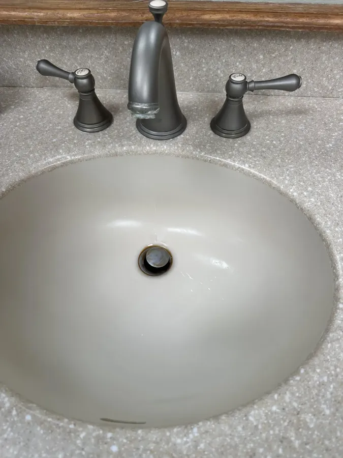 Bathroom sink and fixtures after, spotless and polished