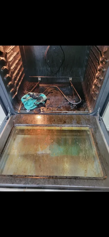 Oven door glass before a move-in clean