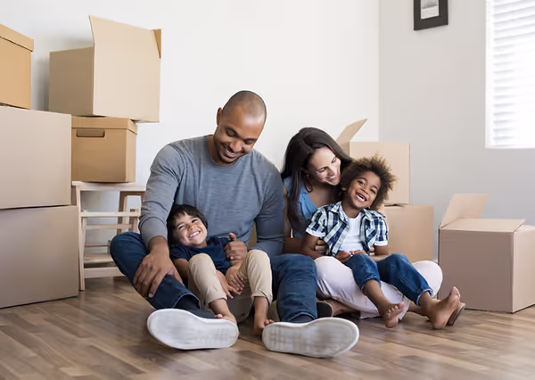 A family among moving boxes in a home on moving day