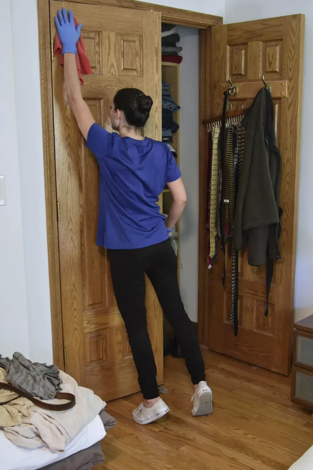 A Happy Maids cleaner detailing a door frame and trim by hand