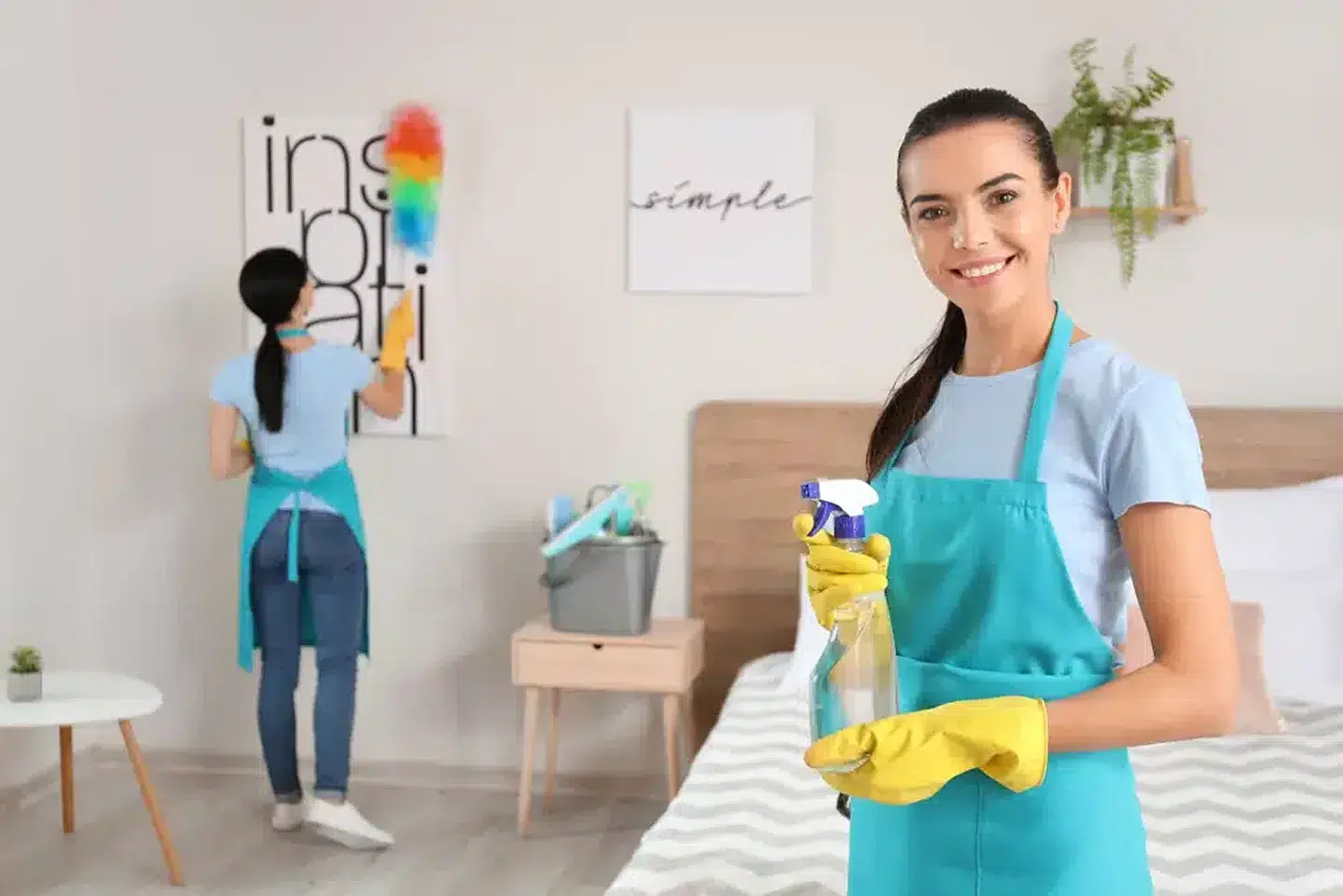 Two women cleaning a modern room.