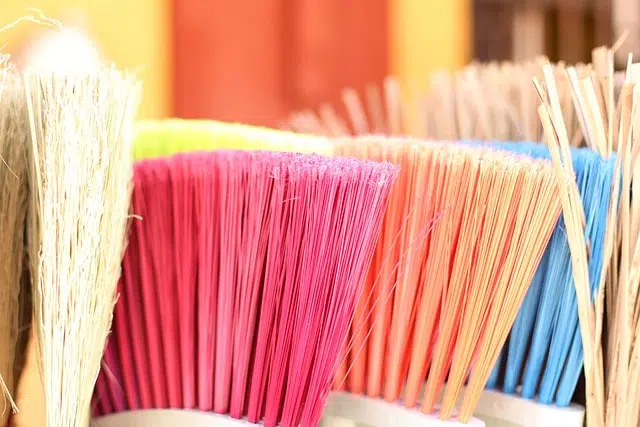 Colorful brooms arranged in display