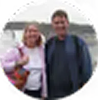 Couple posing near water.