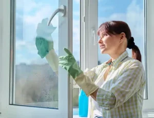 Person cleaning a window with cloth